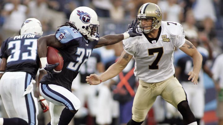 Tennessee Titans kick off returner Pacman Jones stiff-arms New Orleans Saints kicker Steve Weatherford.