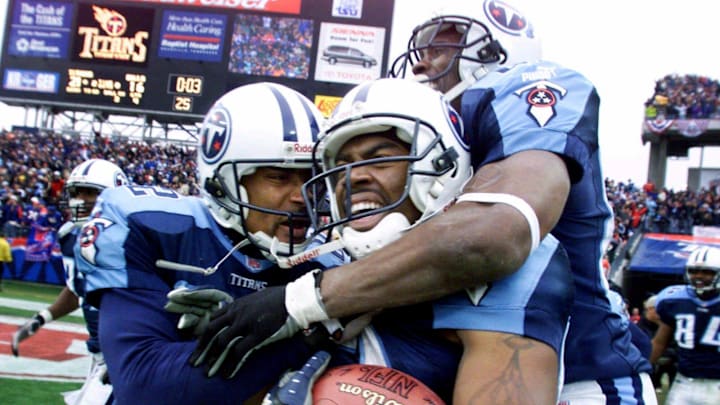 Tennessee Titans wide receiver Kevin Dyson, center, holds onto the ball as he is celebrates with teammates Yancey Thigpen.