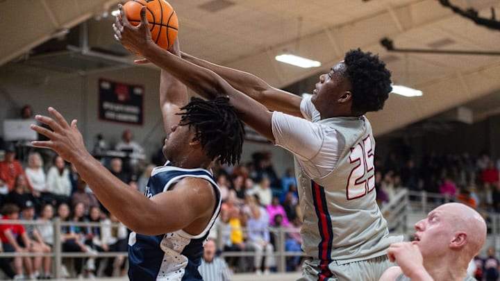 Madison-Ridgeland Academy Patriots' center and power forward Erick Dampier, Jr., (25) reaches for the ball