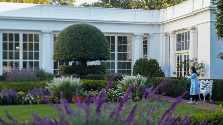 A member of the media takes photos in the Jacqueline Kennedy Garden at the White House during media previews of the White House Garden tours. A member of the media takes photos in the Jacqueline Kennedy Garden at the White House during media previews of the White House Garden tours.