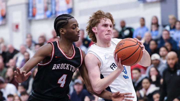 Franklin junior Bradley Herndon drives to the basket with Brockton senior Derron Baker (left) pressuring during the Division 1 Round of 16 MIAA tournament game at Franklin High School on Mar. 07, 2023.

Franklin Boys Basketball Hosts Brockton In The Division 1 Round Of 16 Miaa Tournament Game