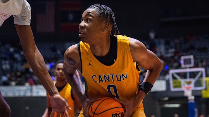 Canton Tigers' Jamarion Davis-Fleming (0) looks for a way to shoot or pass under the basket during the MHSAA Class 5A state championship game against the Holmes County Central Jaguars at the Mississippi Coliseum in Jackson, Miss., on Friday, Feb. 28, 2025.