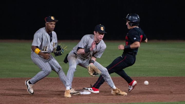 Brandon Bulldogs' Brayson Hall (13) gets to second safely before Oak Grove Warriors' Eli Wheat (2) grabbed the ball during the game in Brandon, Miss., on Friday, April 11, 2025.