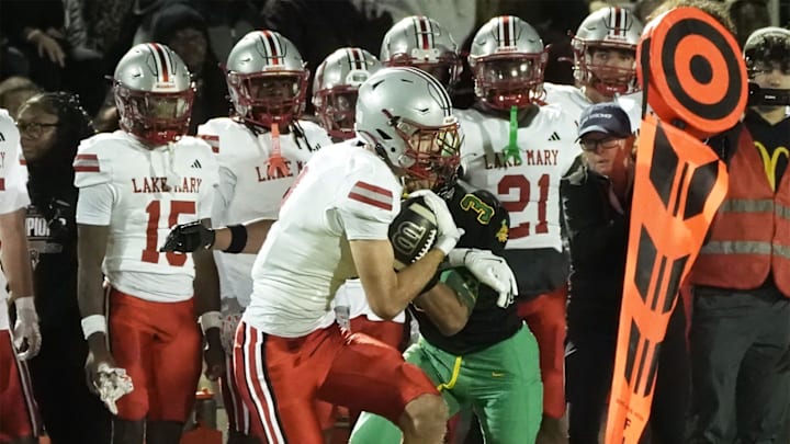 Lake Mary's Barrett Schulz (4) catches the ball down the field and scores a touchdown against DeLand in the Region 1-7A finals, Friday, Nov. 28, 2025, at Spec Martin Stadium. Lake Mary's Barrett Schulz (4) catches the ball down the field and scores a touchdown against DeLand in the Region 1-7A finals, Friday, Nov. 28, 2025, at Spec Martin Stadium.