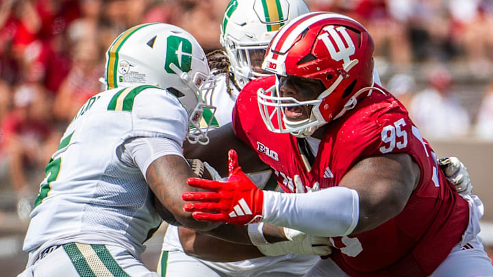 Indiana's Tyrique Tucker (95) tackles Charlotte's Cartevious Norton (5) in the backfield during the Indiana versus Charlotte football game at Memorial Stadium on Saturday, Sept. 21, 2024.