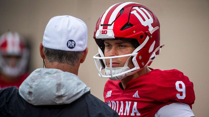 Indiana's Kurtis Rourke (9) talks with a coach before the Maryland football game.