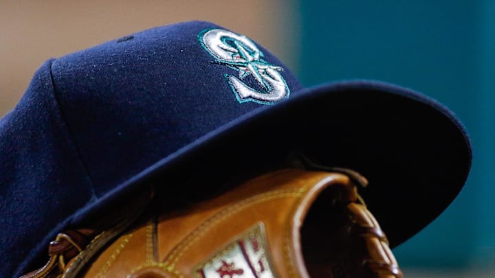 A Seattle Mariners hat sits on top a mitt during a game against the Texas Rangers at Globe Life Park in Arlington. Rangers won 10-4 in 2016. A Seattle Mariners hat sits on top a mitt during a game against the Texas Rangers at Globe Life Park in Arlington. Rangers won 10-4 in 2016.