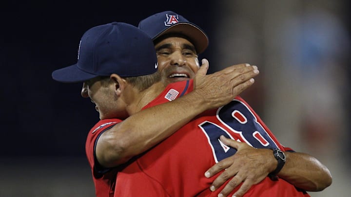 June 17, 2012; Omaha, NE, USA;  Arizona Wildcats head coach Andy Lopez hugs pitcher Konner Wade (48) after throwing a complete game shutout against the UCLA Bruins in game six of the 2012 College World Series at TD Ameritrade Park. Arizona won 4-0. Mandatory Credit: Bruce Thorson-Imagn Images