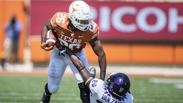 Oct 3, 2020; Austin, TX, USA; Texas Longhorns running back Keaontay Ingram (26) stiff arms TCU Horned Frogs safety La'Kendrick Van Zandt (20) in the 3th quarter in a NCAA college football game at Darrell K Royal-Texas Memorial Stadium. Mandatory Credit: Ricardo B. Brazziell-Imagn Images Oct 3, 2020; Austin, TX, USA; Texas Longhorns running back Keaontay Ingram (26) stiff arms TCU Horned Frogs safety La'Kendrick Van Zandt (20) in the 3th quarter in a NCAA college football game at Darrell K Royal-Texas Memorial Stadium. Mandatory Credit: Ricardo B. Brazziell-Imagn Images