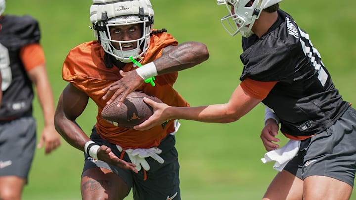 Texas Longhorns Arch Manning hands the ball of to CJ Baxter during the first fall football camp practice for the Texas Longhorns at Denius Fields on Wednesday, July 31, 2024. Texas Longhorns Arch Manning hands the ball of to CJ Baxter during the first fall football camp practice for the Texas Longhorns at Denius Fields on Wednesday, July 31, 2024.