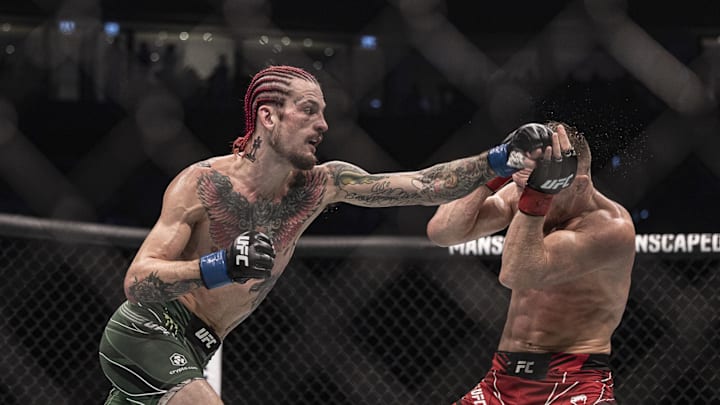Oct 22, 2022; Abu Dhabi, UAE; Petr Yan (red gloves) and Sean O'Malley (blue gloves) during UFC 280 at Etihad Arena. Mandatory Credit: Craig Kidwell-Imagn Images