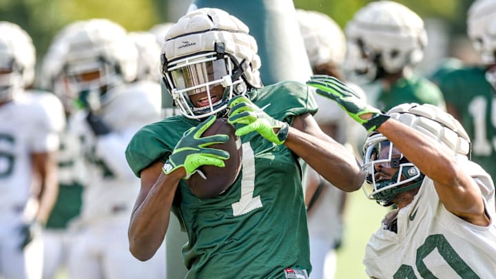 Michigan State receiver Antonio Gates Jr., left, catches a pass as defensive back Justin White