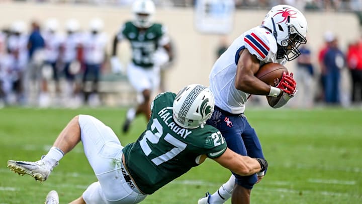 Michigan State's Cal Haladay, left, tackles Richmond's Jasiah Williams during the second quarter on