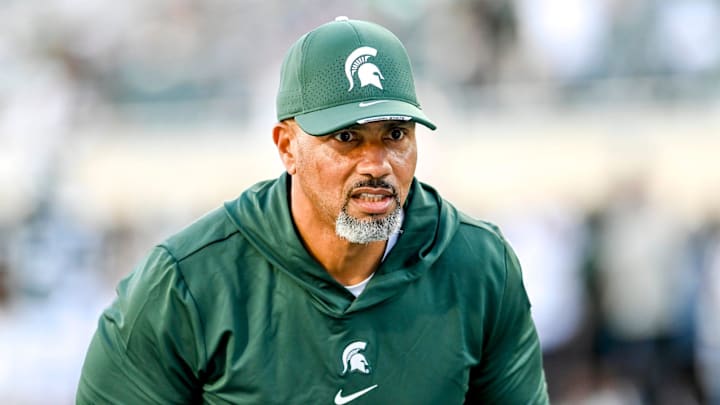 Michigan State's defensive line coach Diron Reynolds works with players before the football game