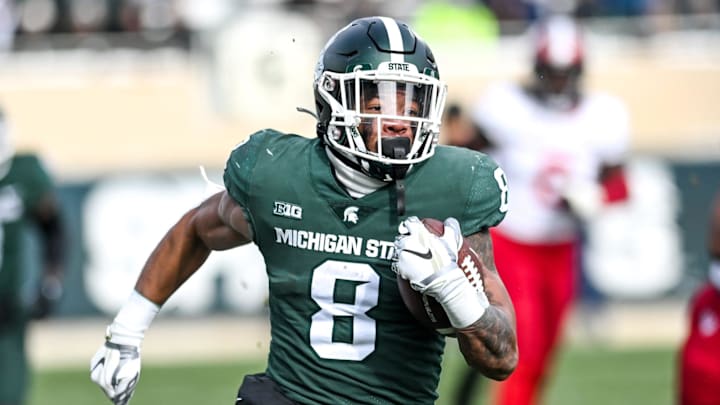 Michigan State's Jalen Berger runs for a gain against Indiana during the second quarter on Saturday,
