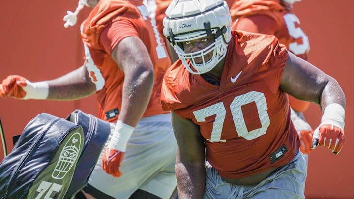 Texas Longhorn offensive linemen Christian Jones (70) runs through drills during their second day of