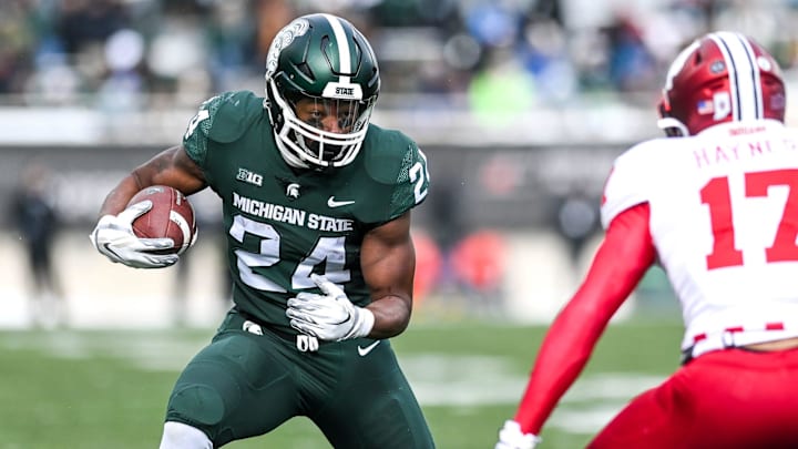 Michigan State's Elijah Collins runs for a gain against Indiana's during the second quarter on