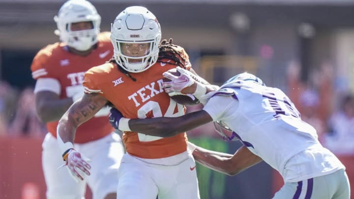 Texas Longhorns running back Jonathon Brooks (24) fights for yardage against Kansas State Wildcats safety Wesley Fair (18) in the second half of an NCAA college football game, Saturday, November. 4, 2023, in Austin, Texas. Texas Longhorns running back Jonathon Brooks (24) fights for yardage against Kansas State Wildcats safety Wesley Fair (18) in the second half of an NCAA college football game, Saturday, November. 4, 2023, in Austin, Texas.