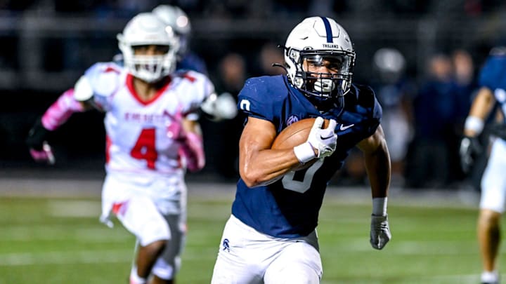 East Lansing's Jace Clarizio runs for a touchdown against Everett during the second quarter on