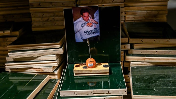 A makeshift good luck shrine to MSU basketball coach Tom Izzo and the team sits on pieces of the basketball court floor the Spartans won the 2000 championship on at the Michigan State University Surplus Store on Thursday, March 23, 2023, in East Lansing. Customers can buy a piece of the historic floor at through the store.

230322 Msu Surplus 033a