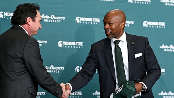 Michigan State football coach Jonathan Smith, left, shakes athletic director Alan Haller's hand during an introductory press conference on Tuesday, Nov. 28, 2023, at the Breslin Center in East Lansing.