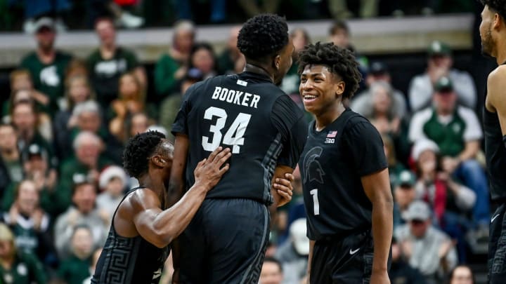 Michigan State's Xavier Booker, center, celebrates his dunk with teammates Tyson Walker, left, and Jeremy Fears Jr. during the first half in the game against Stony Brook on Thursday, Dec. 21, 2023, at the Breslin Center in East Lansing.
