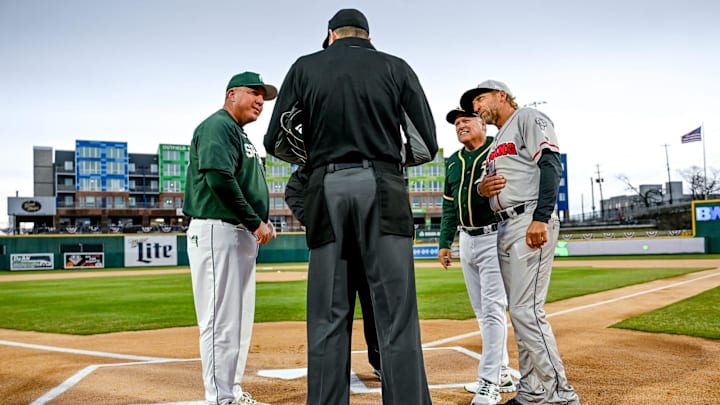 Michigan State's head coach Jake Boss Jr., left, Athletics scout Rich Sparks, center, and Lugnuts' manager Craig Conklin, right, meet with the umpire on Tuesday, April 4, 2023, before the Crosstown Showdown at Jackson Field in Lansing.

230404 Msu Lugnuts Bsball 011a