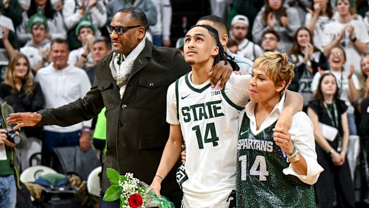 Michigan State's Davis Smith, center, walks with his family including father Steve Smith, left, and mother Millie during the senior night celebration after the game against Northwestern on Wednesday, March 6, 2024, at the Breslin Center in East Lansing.