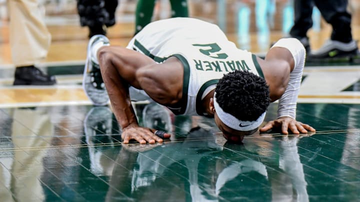 Michigan State senior Tyson Walker kisses the Spartans logo at mid-court during the senior night celebration after the game against Northwestern on Wednesday, March 6, 2024, at the Breslin Center in East Lansing.