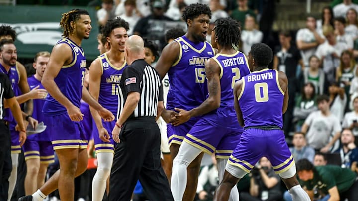 James Madison celebrates after Raekwon Horton (2) made a 3-pointer against Michigan State during overtime on Monday, Nov. 6, 2023, in East Lansing. James Madison celebrates after Raekwon Horton (2) made a 3-pointer against Michigan State during overtime on Monday, Nov. 6, 2023, in East Lansing.
