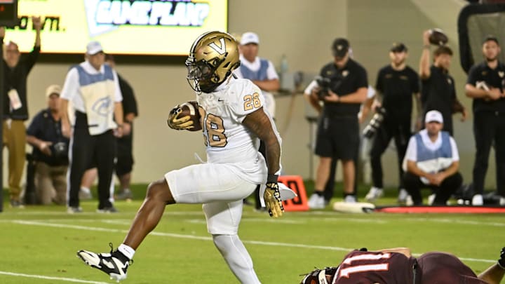 Sep 6, 2025; Blacksburg, Virginia, USA;  Vanderbilt Commodores running back Sedrick Alexander (28) runs for a touchdown after breaking a tackle from Virginia Tech Hokies safety Tyson Flowers (11) during the fourth quarter at Lane Stadium. Mandatory Credit: Brian Bishop-Imagn Images
