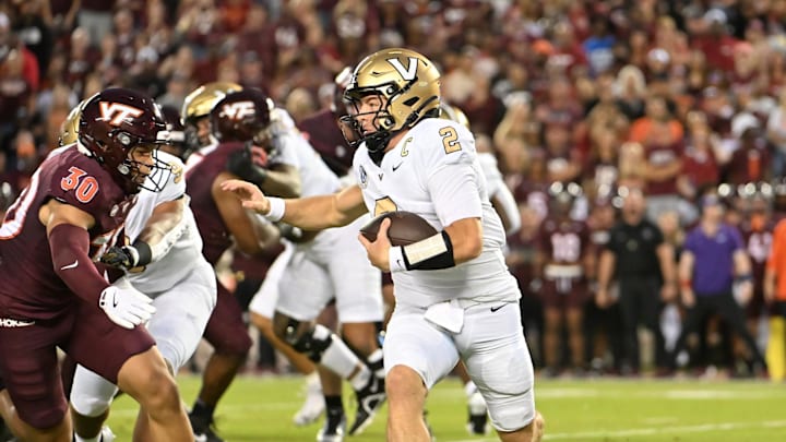 Sep 6, 2025; Blacksburg, Virginia, USA; Vanderbilt Commodores quarterback Diego Pavia (2) runs the ball as Virginia Tech Hokies linebacker Michael Short (30) pursues during the first quarter at Lane Stadium. Mandatory Credit: Brian Bishop-Imagn Images Sep 6, 2025; Blacksburg, Virginia, USA; Vanderbilt Commodores quarterback Diego Pavia (2) runs the ball as Virginia Tech Hokies linebacker Michael Short (30) pursues during the first quarter at Lane Stadium. Mandatory Credit: Brian Bishop-Imagn Images