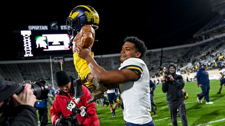 Michigan's Will Johnson celebrates with the Paul Bunyan trophy after beating Michigan State on Saturday, Oct. 21, 2023, at Spartan Stadium in East Lansing. Michigan's Will Johnson celebrates with the Paul Bunyan trophy after beating Michigan State on Saturday, Oct. 21, 2023, at Spartan Stadium in East Lansing.