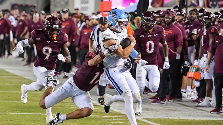Sep 13, 2025; Blacksburg, Virginia, USA;  Virginia Tech Hokies safety Tyson Flowers (11) tackles Old Dominion Monarchs quarterback Colton Joseph (1) during the third quarter at Lane Stadium. Mandatory Credit: Brian Bishop-Imagn Images