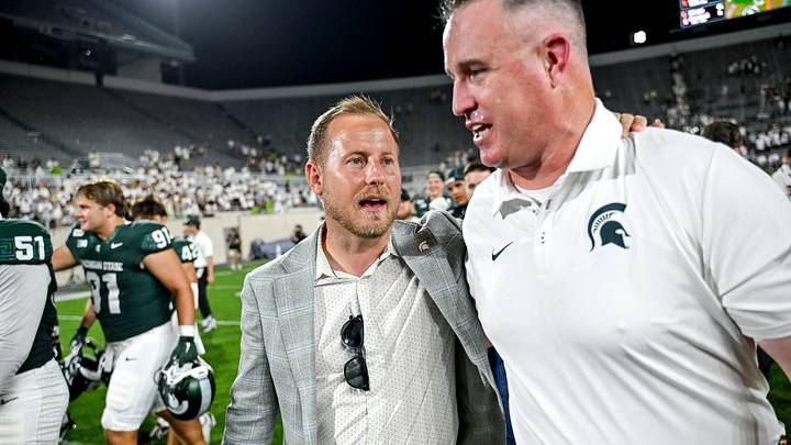 Michigan State Athletic Director Dan Bartholomae, left, talks with football coach Pat Fitzgerald after the Spartans win over Toledo on Friday, Sept. 4, 2026, at Spartan Stadium in East Lansing.