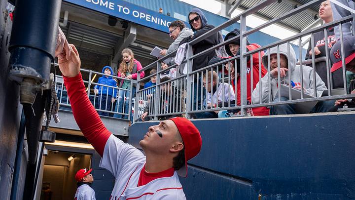 Players Tsung-Che Cheng, left, and Mikey Romero sign autographs and greet fans before they take the field on Opening Day March 27 at Polar Park.