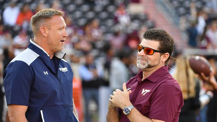 Sep 13, 2025; Blacksburg, Virginia, USA;  Virginia Tech Hokies head coach Brent Pry and Old Dominion Monarchs head coach Ricky Rahne talk before the game at Lane Stadium. Mandatory Credit: Brian Bishop-Imagn Images