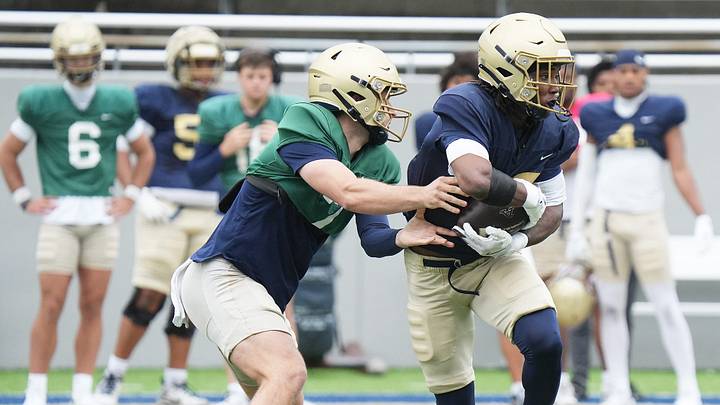 Akron Zips quarterback Reese Poffenbarger hands off to running back Sean Patrick during UA's Spring Showcase on April 25, 2026, in Akron.