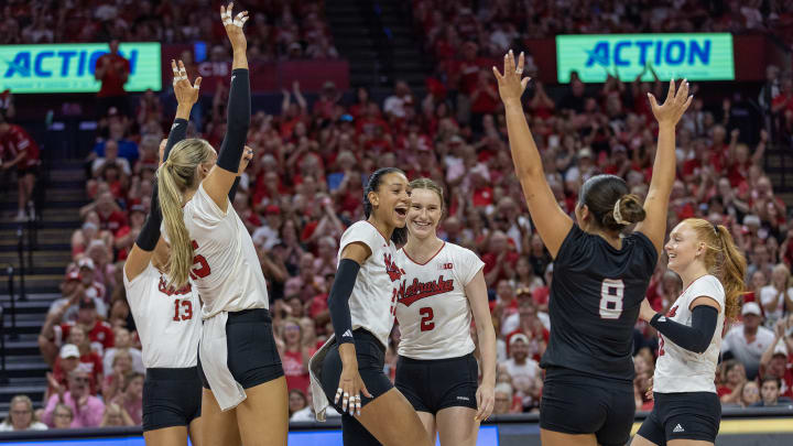 Nebraska volleyball players celebrate a point against TCU.