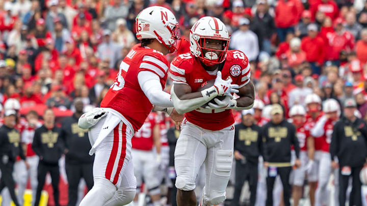 Nebraska running back Emmett Johnson takes a handoff from quarterback Dylan Raiola against Northwestern.