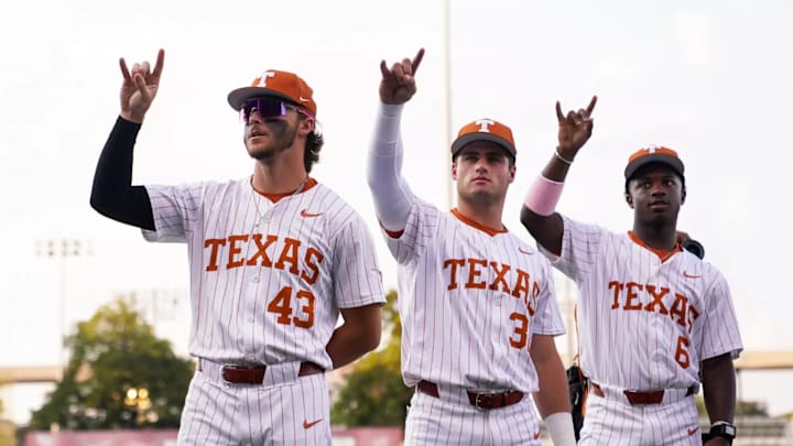 Texas Longhorns Aiden Robbins, Maddox Monsour and Anthony Pack Jr. throw up the Hook 'Em Horns.