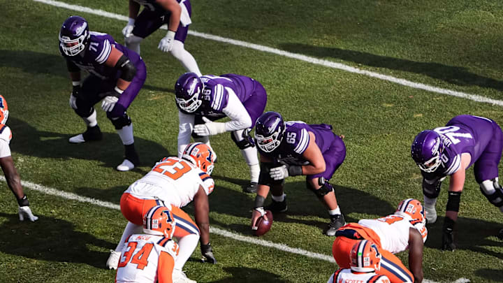 The Northwestern Wildcats prepare to snap the ball against the Illinois Fighting Illini at Wrigley Field on November 30, 2024. The Northwestern Wildcats prepare to snap the ball against the Illinois Fighting Illini at Wrigley Field on November 30, 2024.
