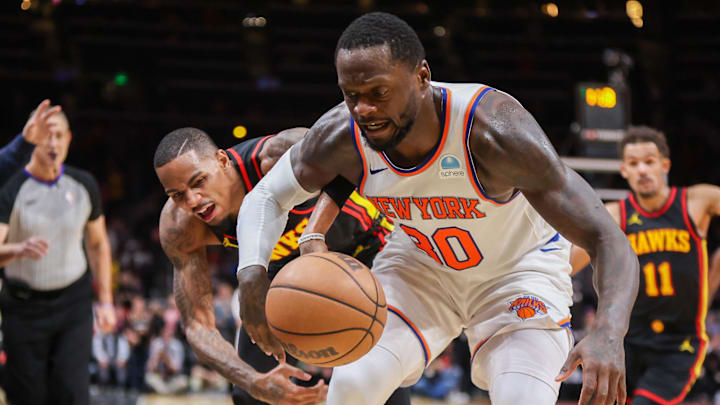 Nov 15, 2023; Atlanta, Georgia, USA; New York Knicks forward Julius Randle (30) and Atlanta Hawks guard Dejounte Murray (5) reach for a loose ball in the second half at State Farm Arena. Mandatory Credit: Brett Davis-USA TODAY Sports