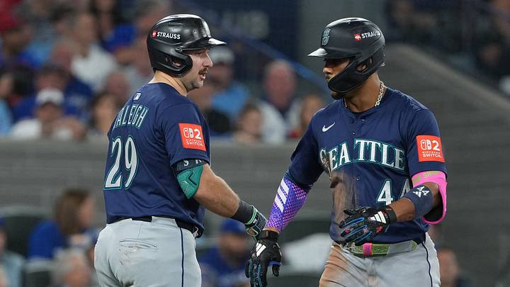 Oct 20, 2025; Toronto, Ontario, CAN; Seattle Mariners center fielder Julio Rodriguez (44) celebrates with catcher Cal Raleigh (29) after hitting a home run in the third inning against the Toronto Blue Jays during game seven of the ALCS round for the 2025 MLB playoffs at Rogers Centre. Mandatory Credit: Nick Turchiaro-Imagn Images