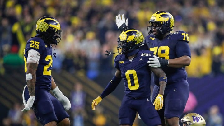 Michigan defensive back Mike Sainristil (0) celebrates a play against Washington during the first