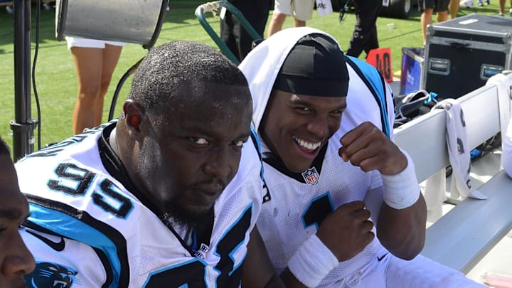 Sep 22, 2013; Charlotte, NC, USA; Carolina Panthers defensive end Charles Johnson (95) and quarterback Cam Newton (1) react late in the fourth quarter. The Carolina Panthers defeated the New York Giants 38-0 at Bank of America Stadium. Mandatory Credit: Bob Donnan-Imagn Images