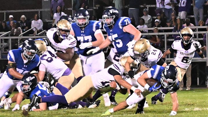 Christian Brothers Academy defenders Tre' Williams and Christian Giannone (24) tackle Whitesboro ball-carrier Connor McDonald Friday, Sept. 5, 2025, at Chiz Frye Field in Whitesboro, New York.
