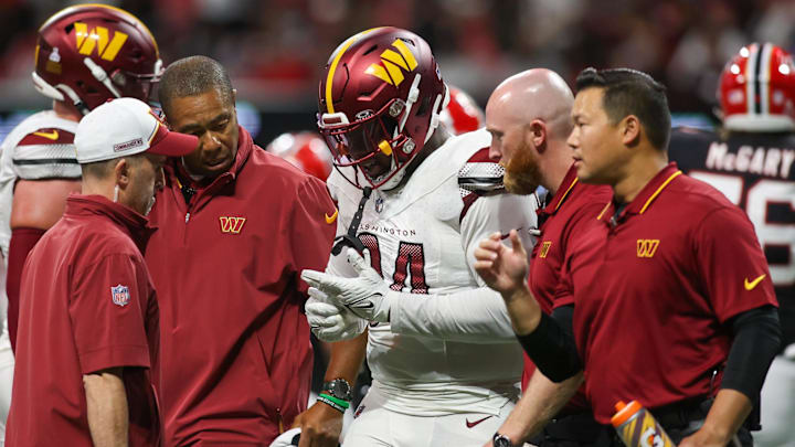 Washington Commanders defensive tackle Daron Payne goes off the field with an injury.