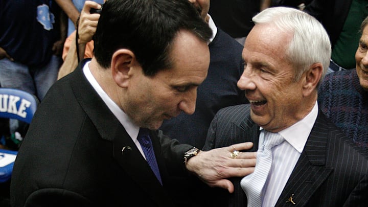 Mar 8, 2014; Durham, NC, USA; Duke Blue Devils head coach Mike Krzyzewski and North Carolina Tar Heels head coach Roy Williams greet each other before the start of their game at Cameron Indoor.