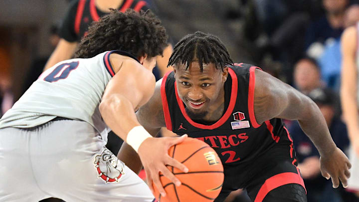 Dec 29, 2023; Spokane, Washington, USA; San Diego State Aztecs guard Darrion Trammell (12) defends agaistn Gonzaga Bulldogs guard Ryan Nembhard (0) in the second half at McCarthey Athletic Center. Mandatory Credit: James Snook-Imagn Images